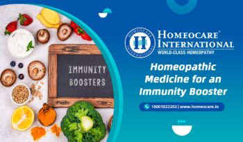 Banner advertising Homeocare International immunity boosters with a chalkboard reading 'IMMUNITY BOOSTERS' and a colorful fruit/vegetable collage on the left.